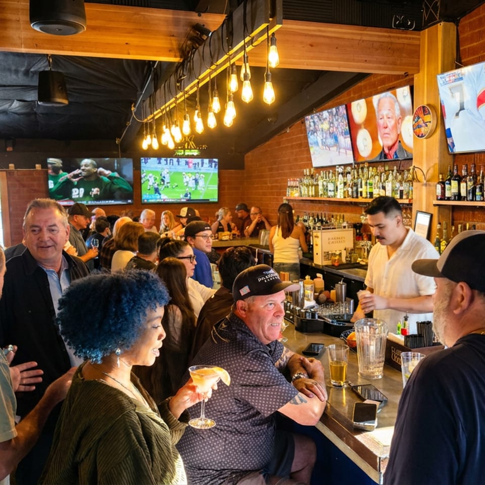 Busy sports bar with patrons enjoying drinks, televisions showing hockey and football, and a bartender serving behind the counter.