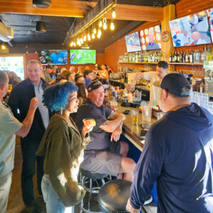 Customers sitting at the Mom Said Yes Pizza Torrance Bar