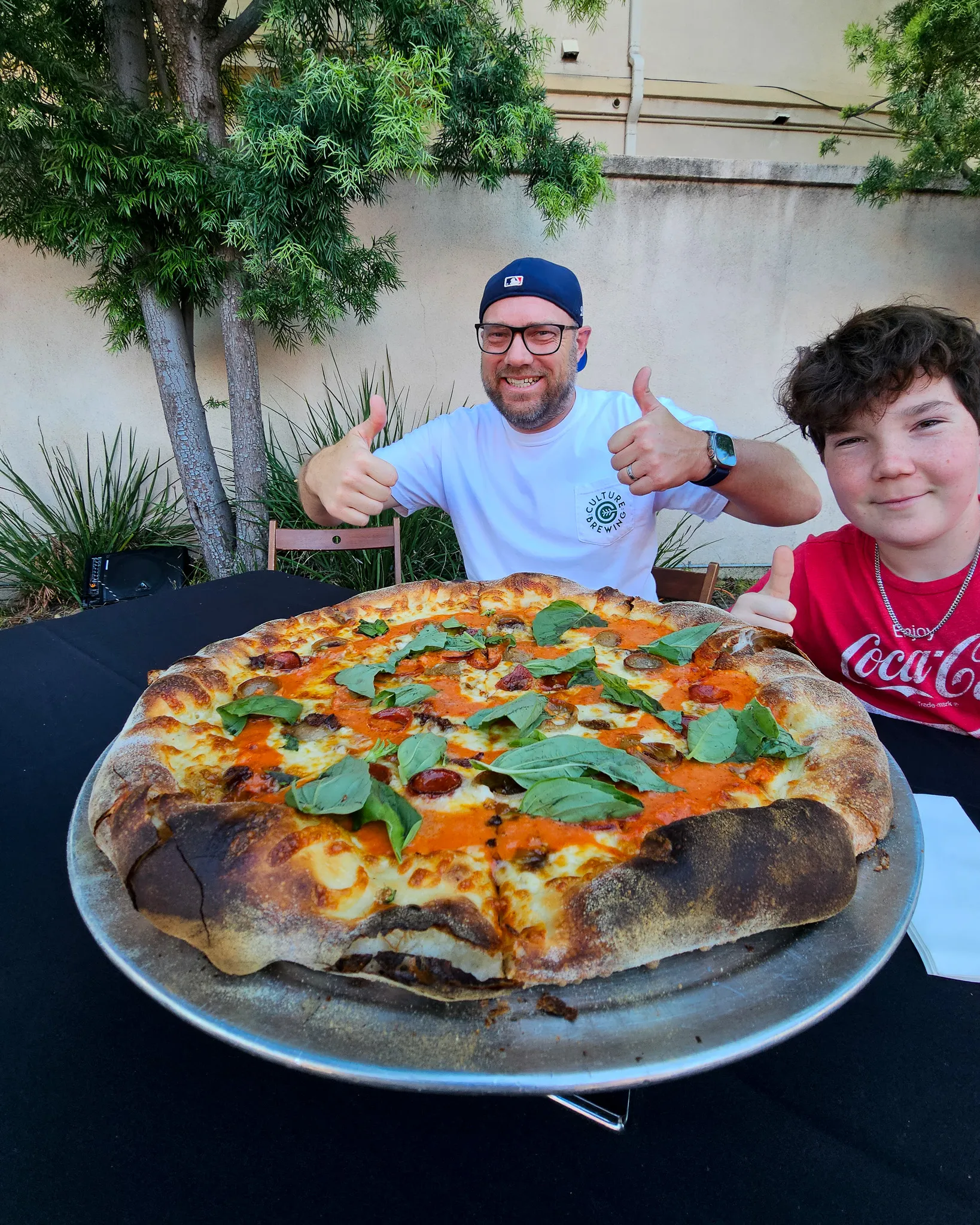 Customer eating New York style pizza at Mom Said Yes in Torrance